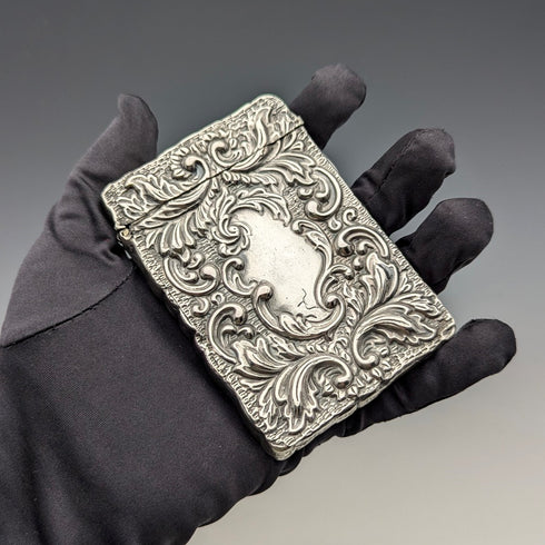 Antique American sterling silver card case with embossed decoration, 75g