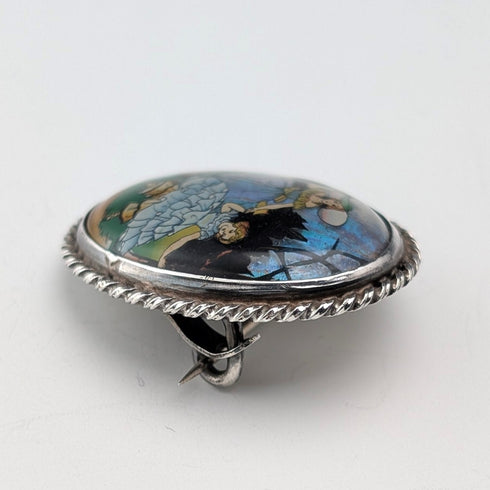 Vintage British sterling silver oval brooch featuring two women with butterfly wings