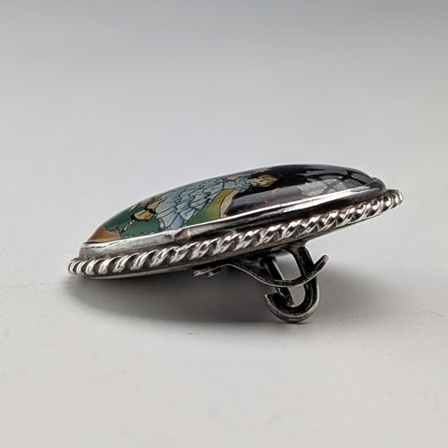 Vintage British sterling silver oval brooch featuring two women with butterfly wings