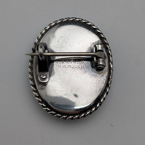 Vintage British sterling silver oval brooch featuring two women with butterfly wings