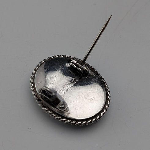 Vintage British sterling silver oval brooch featuring two women with butterfly wings