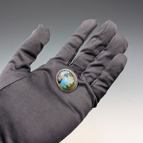 Vintage British sterling silver oval brooch featuring two women with butterfly wings