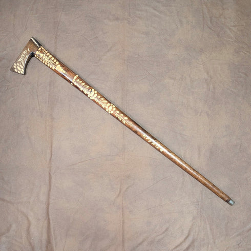 Vintage brown shaft walking stick with carved wood accents and an axe-shaped handle, 85cm