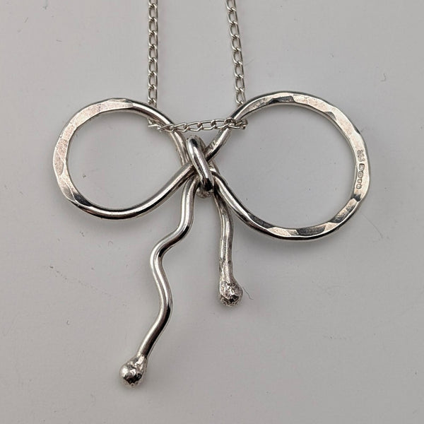 British vintage sterling silver ribbon design pendant with sterling silver chain.