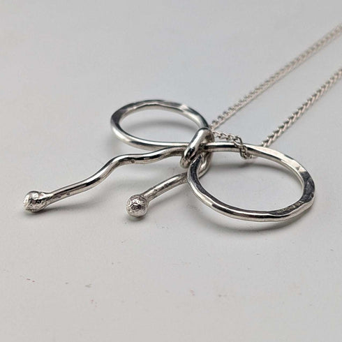 British vintage sterling silver ribbon design pendant with sterling silver chain.