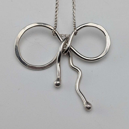 British vintage sterling silver ribbon design pendant with sterling silver chain.
