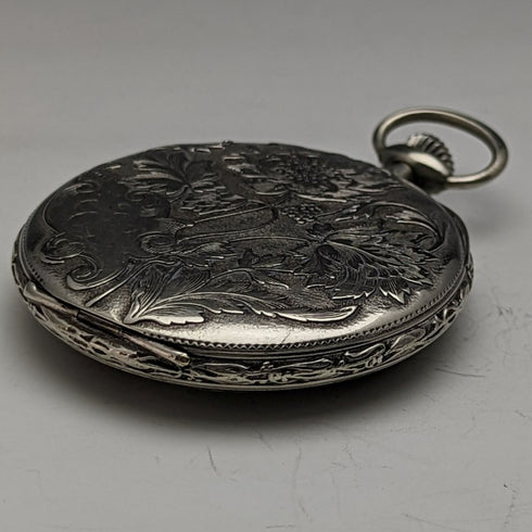 Reloj de bolsillo antiguo sin marca, grabado floral Art Nouveau, caja de aleación, en buen estado de funcionamiento